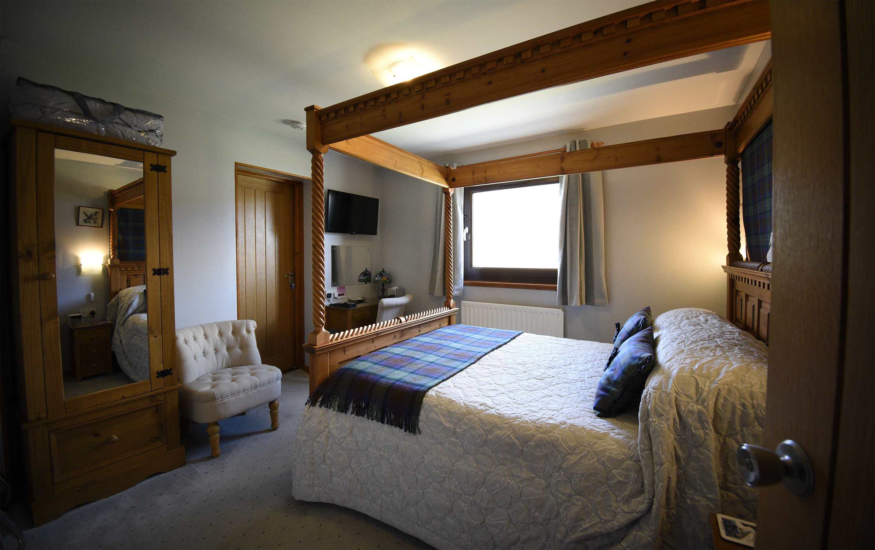 Relax in Taransay House Luxury Accommodation in Portree public seating area with woodburning stove